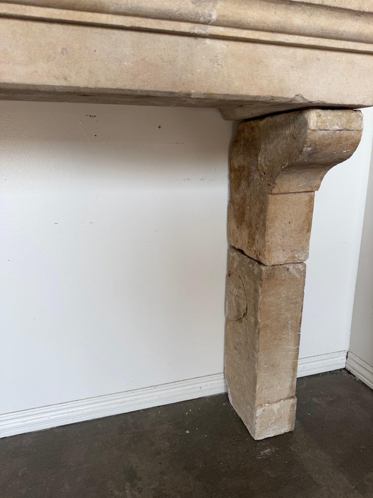 Petite 18th Century French Limestone Fireplace Mantel With Scrolled Corbels