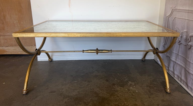 Curule Gilt Iron Coffee Table with Antiqued Mirror Top by Miamar Home