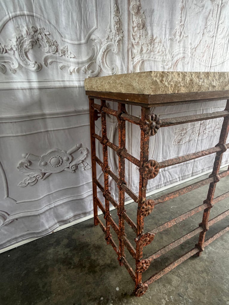 Rustic Console Table with Textured Stone Top and Hand-Forged Iron Base