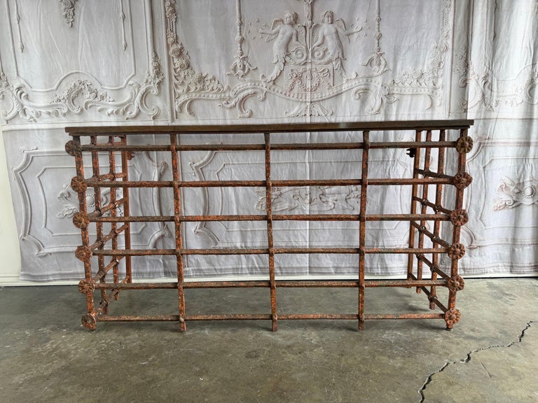 Rustic Console Table with Textured Stone Top and Hand-Forged Iron Base