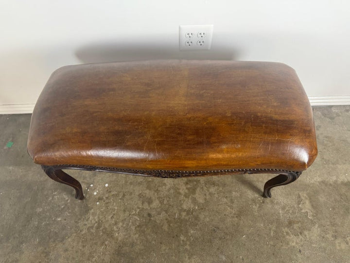 French Louis XV Style Carved Bench with Distressed Leather Upholstery