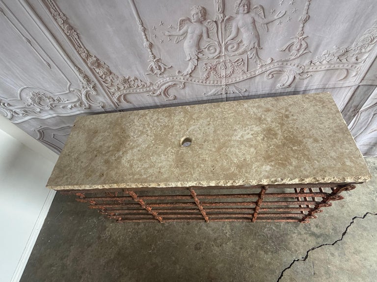 Rustic Console Table with Textured Stone Top and Hand-Forged Iron Base