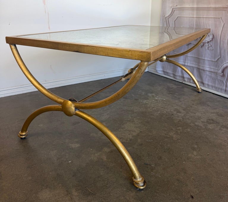 Curule Gilt Iron Coffee Table with Antiqued Mirror Top by Miamar Home