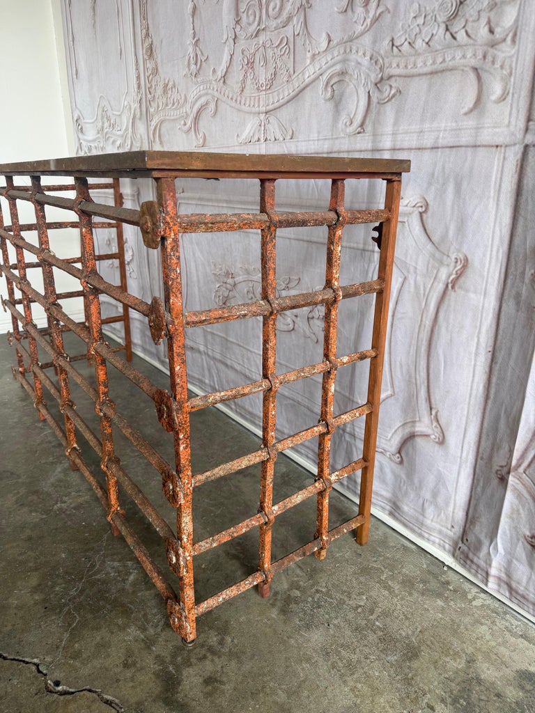 Rustic Console Table with Textured Stone Top and Hand-Forged Iron Base