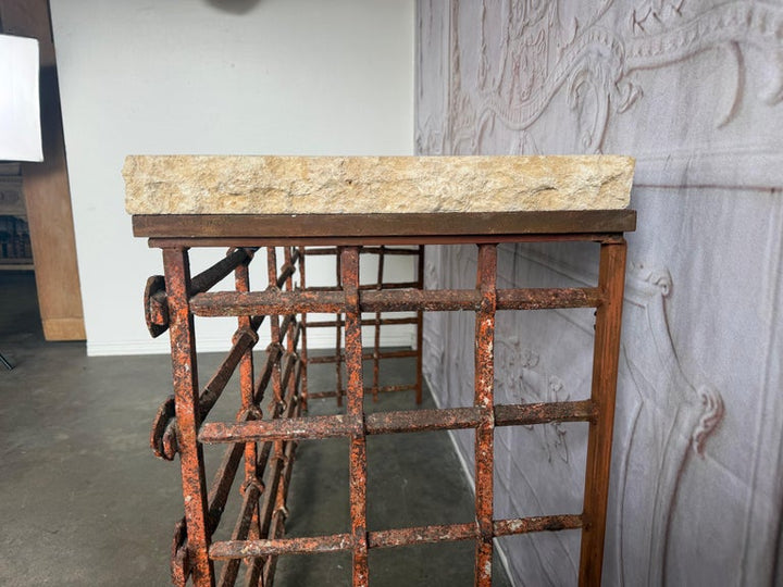 Rustic Console Table with Textured Stone Top and Hand-Forged Iron Base