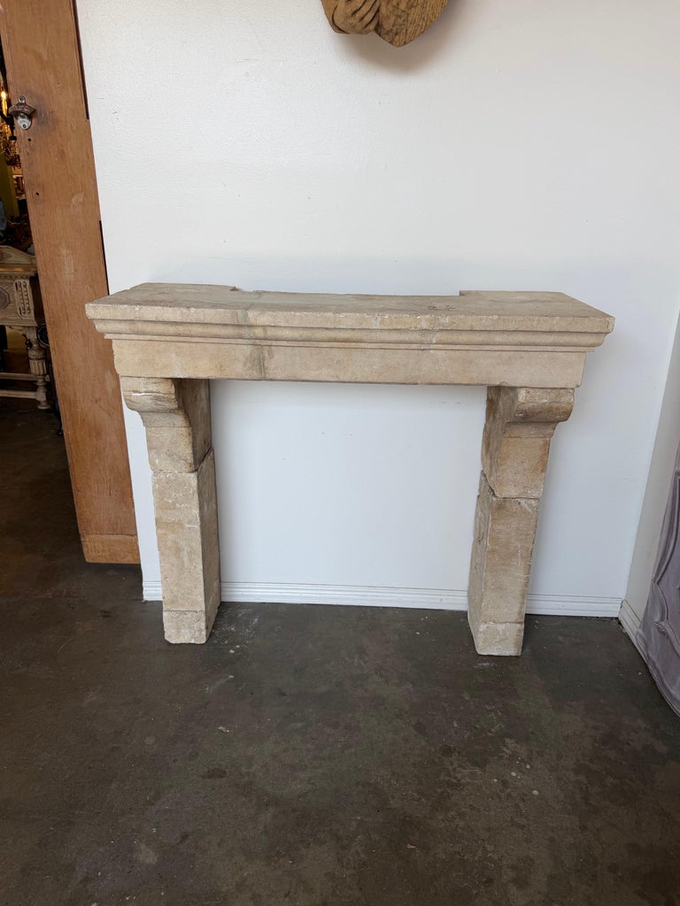 Petite 18th Century French Limestone Fireplace Mantel With Scrolled Corbels