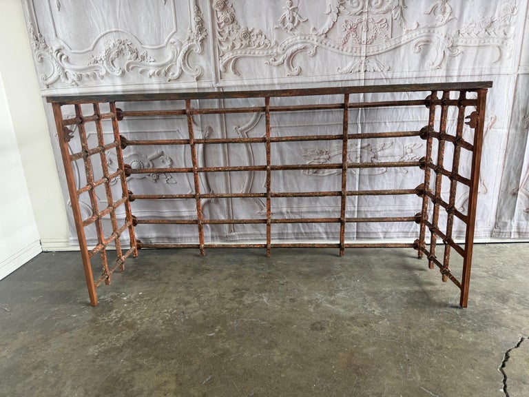 Rustic Console Table with Textured Stone Top and Hand-Forged Iron Base