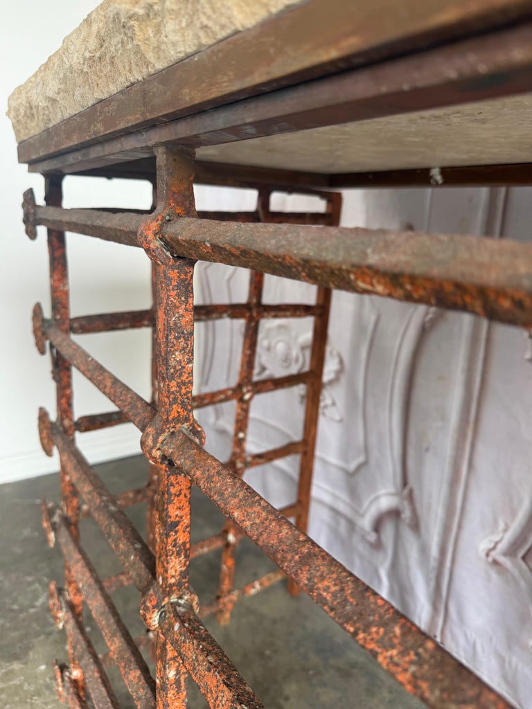 Rustic Console Table with Textured Stone Top and Hand-Forged Iron Base