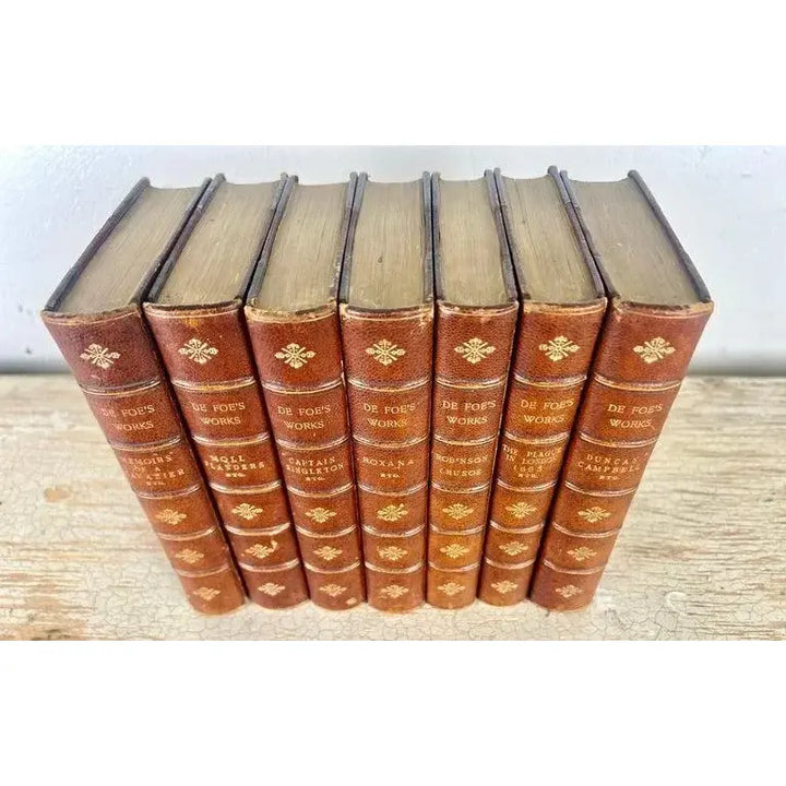 Set of Seven Leather Volumes of Daniel De Foe's Works